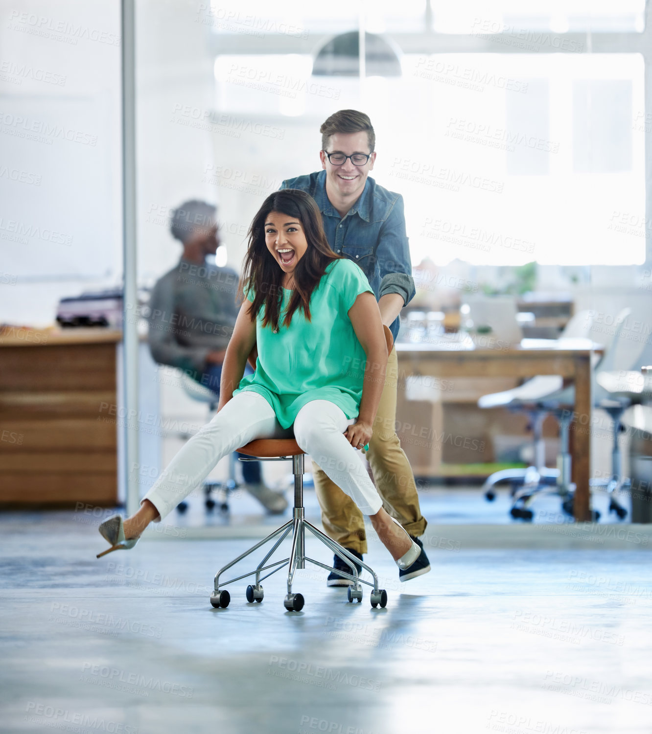 Buy stock photo Startup, celebration or business women push chair for happiness, investment growth or office success in company workspace. Diversity, fun and people with excited face for playing, achievement and win