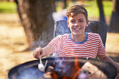 Buy stock photo Boy, campfire and marshmallow for roasting, smile and happiness outside in nature. Camper, sunshine and vacation for relaxation, adventure and childhood memories with sweet snack and outdoor camping