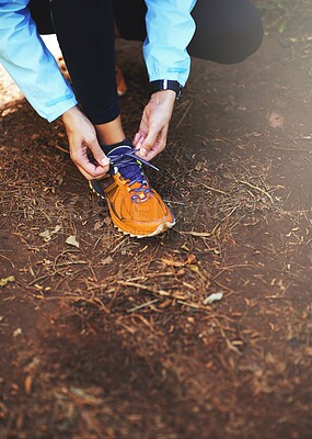 Buy stock photo Hands, runner and tie shoelace on ground for training, exercise or fitness in nature, morning and outdoor. Person, athlete and prepare with shoes, sneakers or workout for health on countryside path