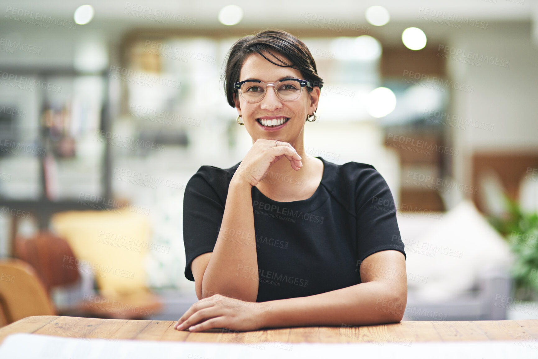 Buy stock photo Design, portrait and smile with woman at desk in office for artistic or creative occupation. Company, glasses and wooden table with happy young designer in workplace for start of career or project