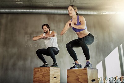 Buy stock photo Man, woman and box jump for gym exercise or training workout for cardio athlete, wellness or fitness center. Friends, equipment and sports growth or physical activity with squat, routine or strength