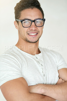 Buy stock photo Portrait, glasses or happy man with fashion, arms crossed or confidence on white background in studio. Face, person and model with tshirt, stylish clothes and trendy outfit with pride, style or smile