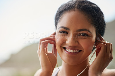 Buy stock photo Female runner, portrait or water with headphones in nature for exercise, listening or streaming for workout. Woman, natural smile or bottle for training by ocean, trail running in Brazil for wellness