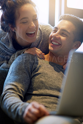 Buy stock photo Laugh, couple and relax on sofa at house together in living room with affection, bonding and love on weekend. Smile, man and woman in relationship in lounge streaming on laptop for entertainment