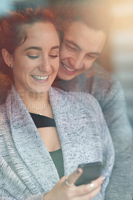 Buy stock photo Home, hug and couple with smile, smartphone and typing with good news, online reading and social media. Apartment, embrace and man with woman, cellphone and texting with internet, love or digital app