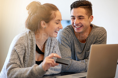 Buy stock photo Man, woman and happy in home with credit card, laptop and online shopping for apartment. E commerce, technology and internet or banking with couple, budget and love or pride together in living room