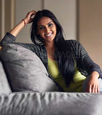 Buy stock photo Portrait, relax and Indian girl with smile, sofa and confident in weekend, break and rest in living room. Home, happiness and woman on couch, lounge and cheerful in apartment, cozy and person