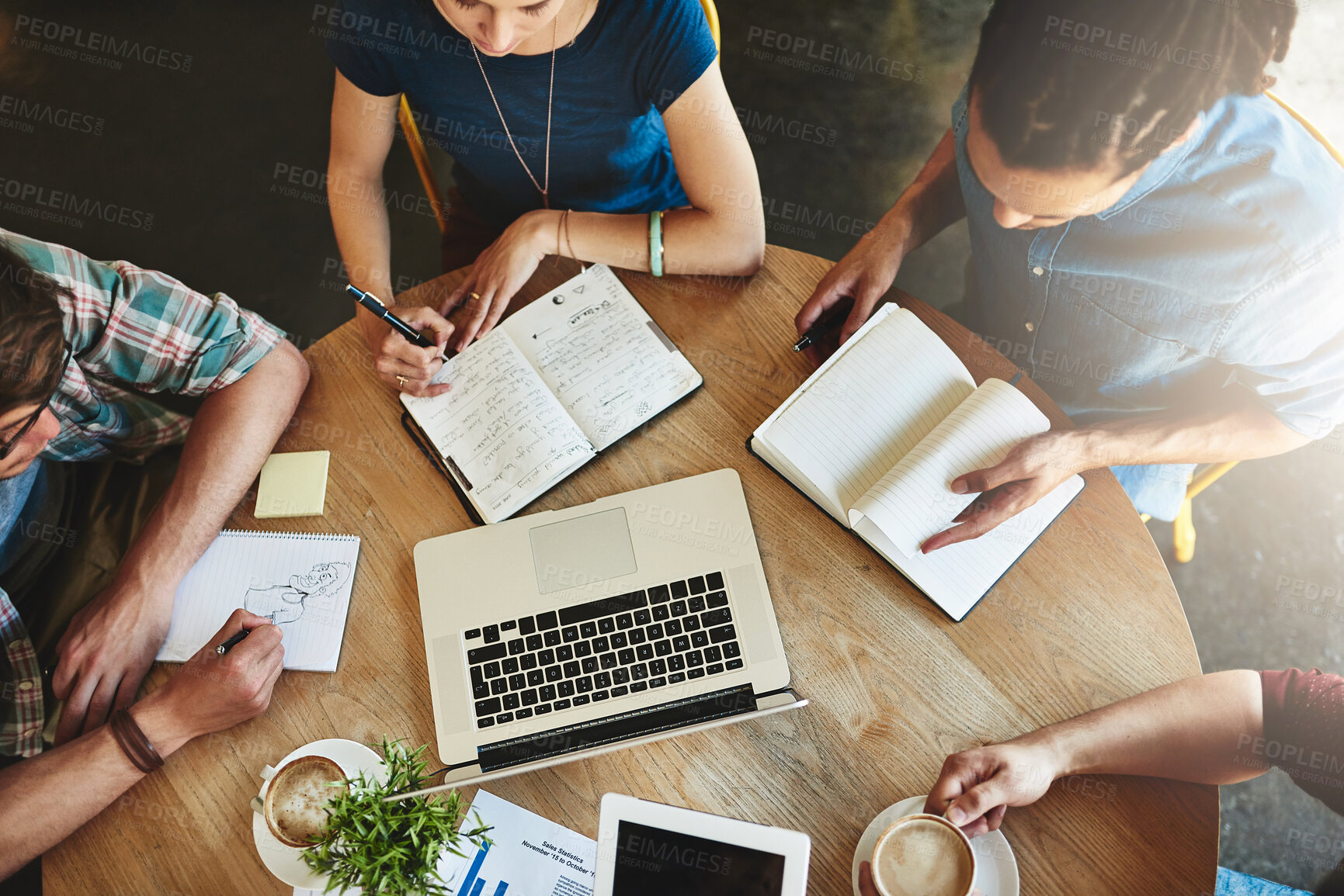 Buy stock photo High angle shot of a group of students studying in a coffee shop