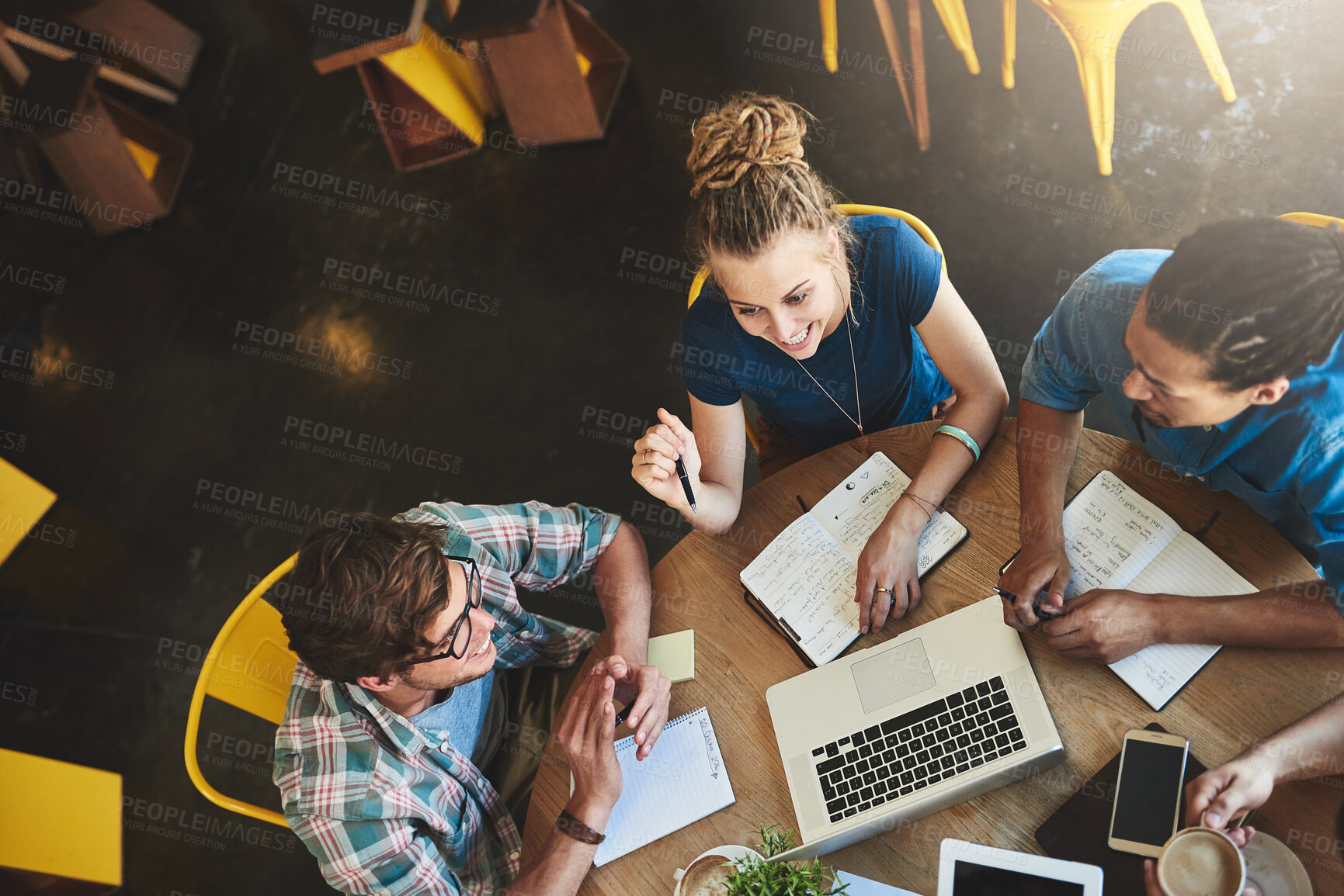 Buy stock photo High angle shot of a group of students studying in a coffee shop