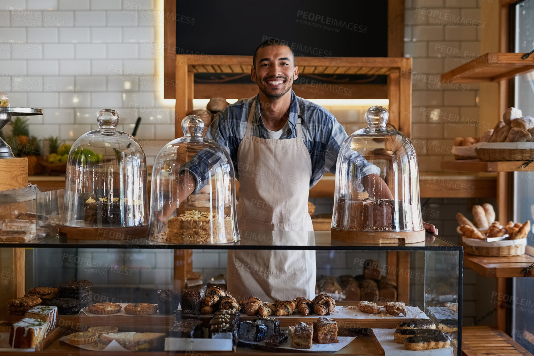 Buy stock photo Coffee shop, portrait and happy man waiter in bakery for store welcome, help and friendly hospitality service. Retail, startup and cafe or restaurant server with cake, cookies or counter assistance