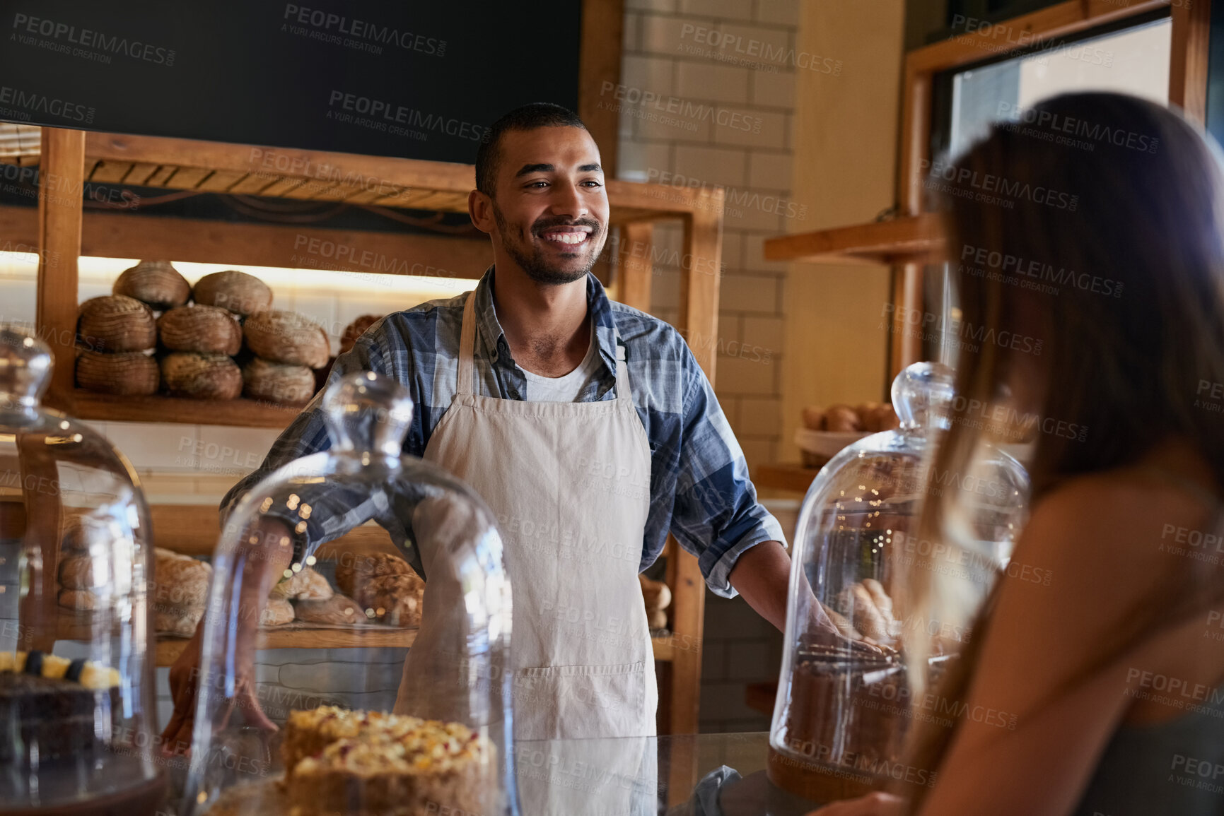 Buy stock photo Bakery, happy and man in cafe with customer for serving pastry, cakes and baked foods for small business. Restaurant, coffee shop and waiter or barista by counter for service, help and talk to woman