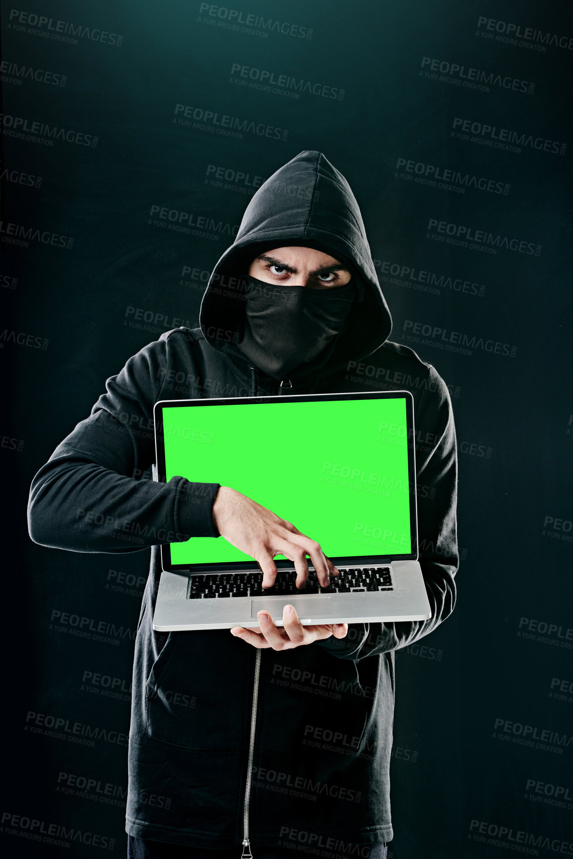 Buy stock photo Man, laptop and portrait on black background for hacking, phishing and malware with green screen. Hacker, technology and software for cyber crime, hacktivism or cryptocurrency thief with mockup space