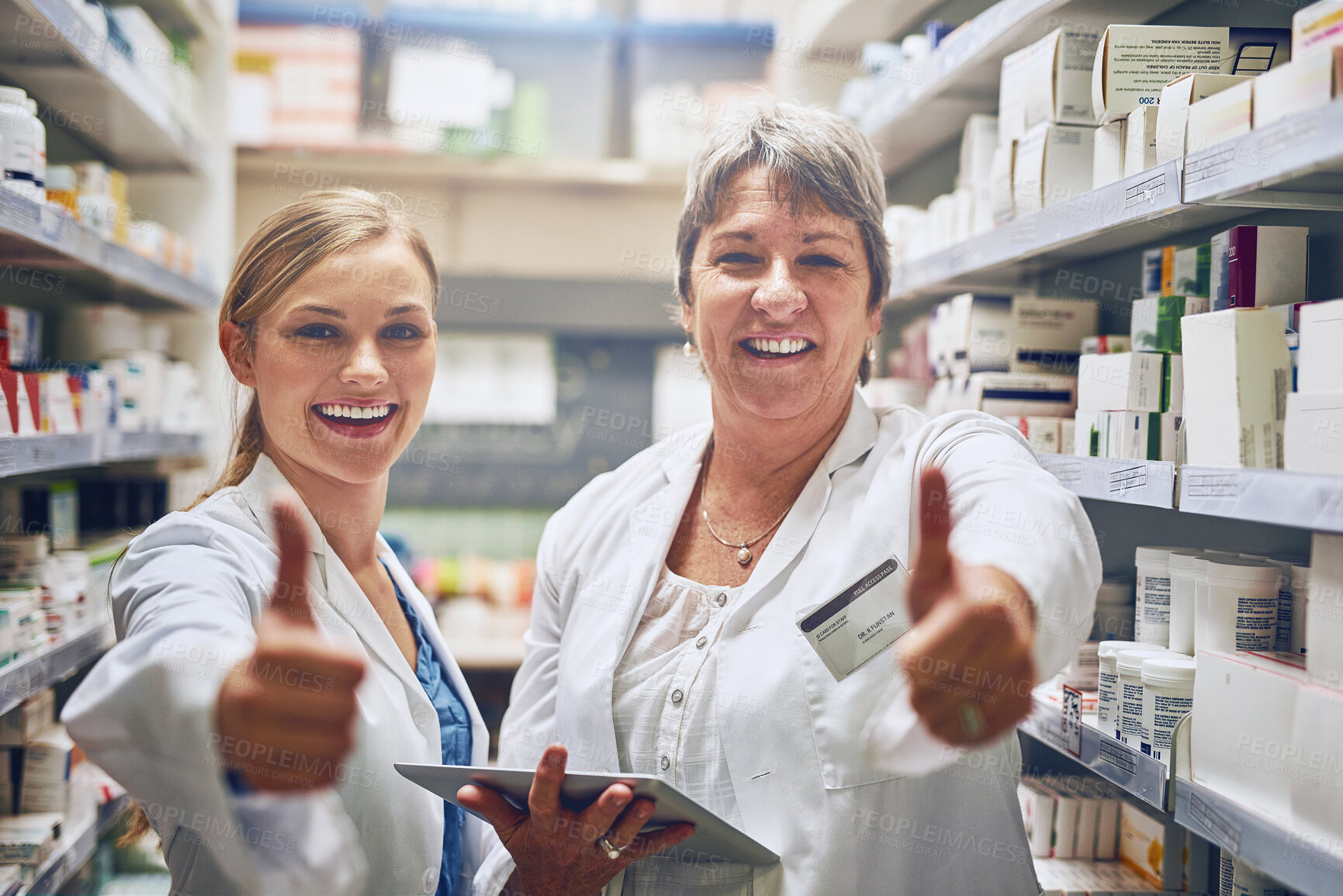 Buy stock photo Shot of pharmacists showing thumbs up in a isle