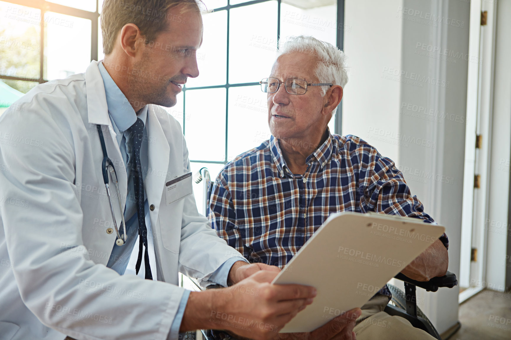 Buy stock photo Doctor, man and wheelchair with clipboard in hospital for consulting, report or medical review. Medic, checklist and person with disability in clinic for paperwork, exam or health insurance for care