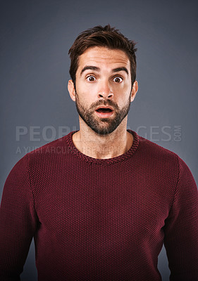 Buy stock photo Studio, shocked and man with news, portrait and gossip of discount, wow and and rumor in mockup space. Gray background, face and person with shock, secret and fear for phobia and scared with alert