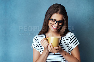 Buy stock photo Woman, student and coffee in studio with smile, drink and glasses on blue background. Mock up, caffeine and energy or health for learner person, hands and matcha or green tea for hydration and relax