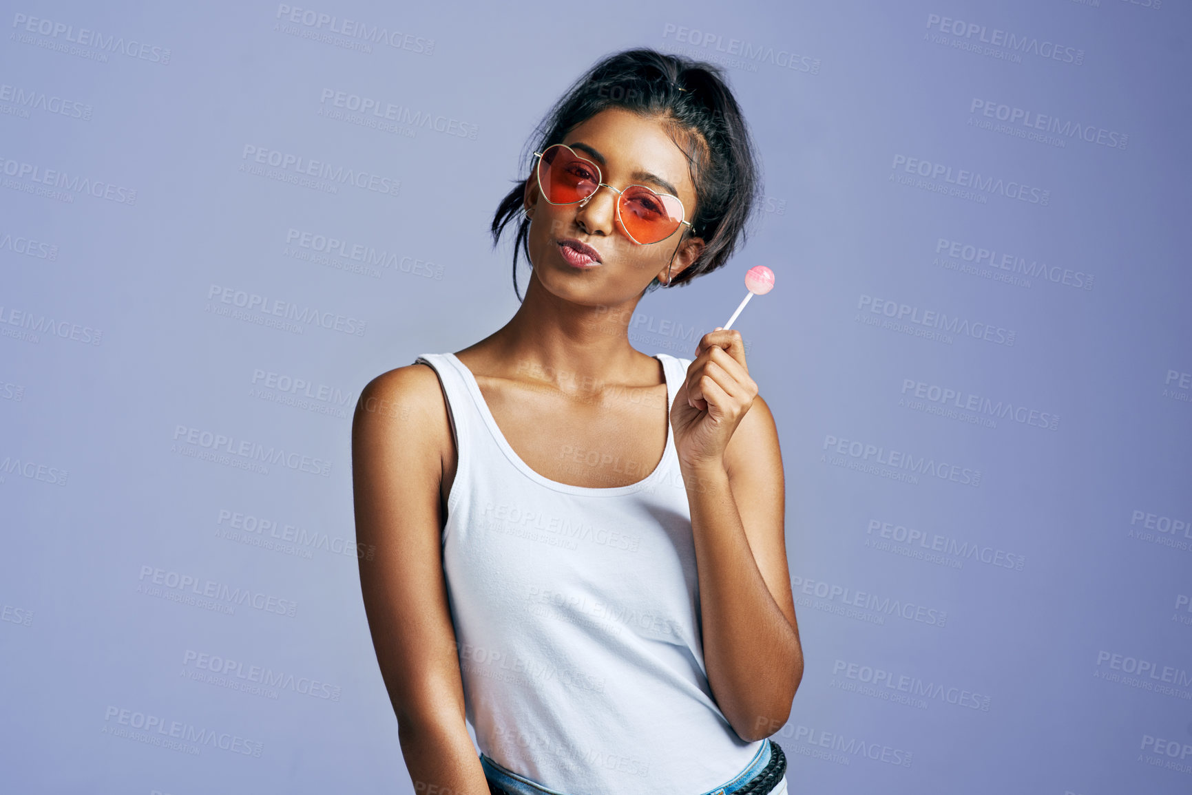 Buy stock photo Girl, lollipop and confident with sunglasses in studio on purple  background in casual, style and elegant. Portrait, fashion and happy or smile for eyewear or street wear, outfit and satisfied