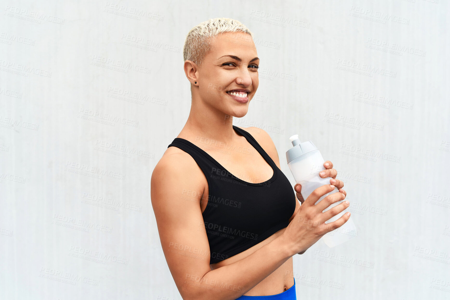 Buy stock photo Woman, athlete and drinking water in studio, portrait and hydrate after workout on white background. Female person, nutrition and mineral liquid for recovery after exercise, fitness and mockup space