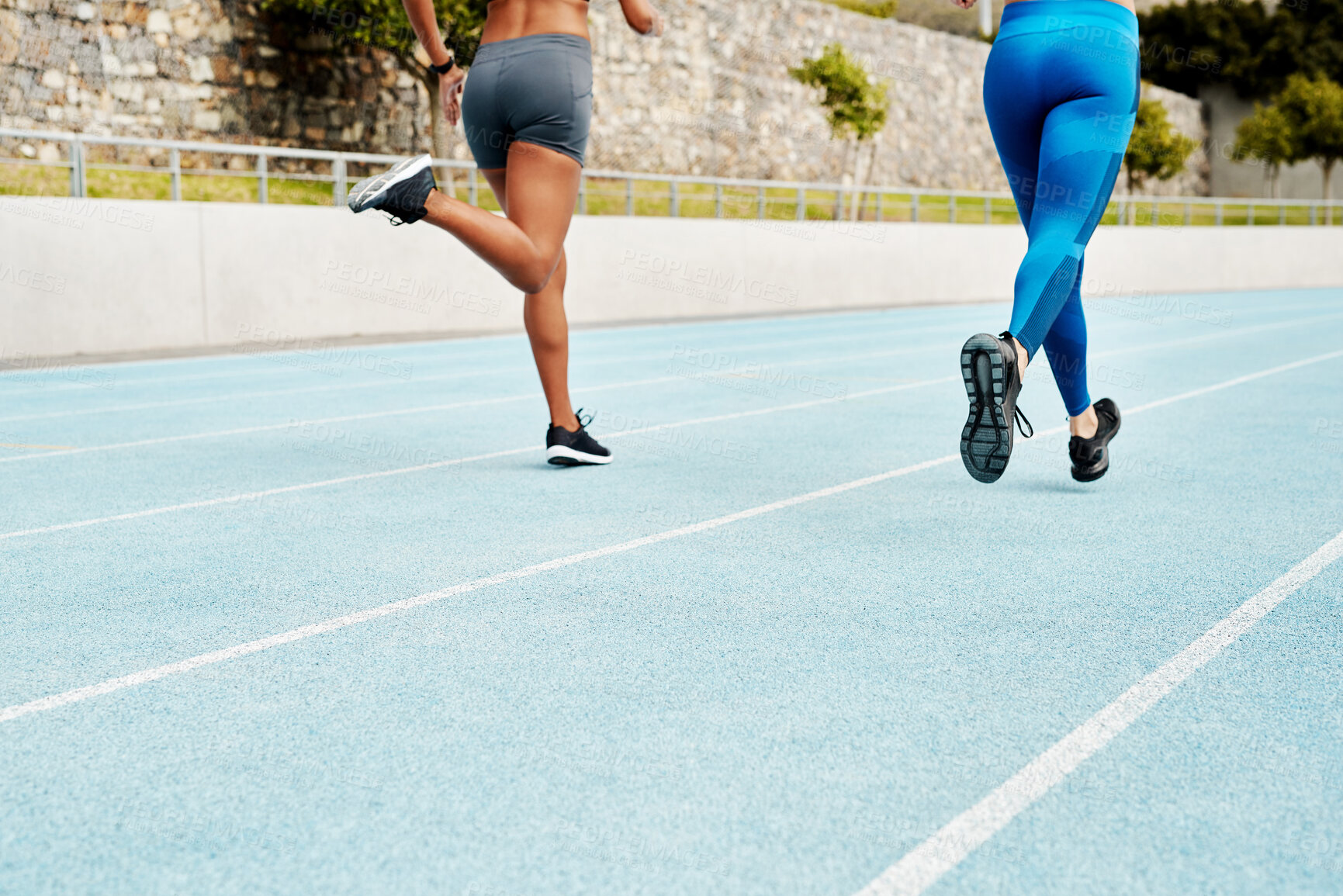 Buy stock photo People, legs or runners on track for exercise, training or outdoor fitness workout with energy. Teamwork, back or athletes running in stadium with speed or motion for practice, wellness or health