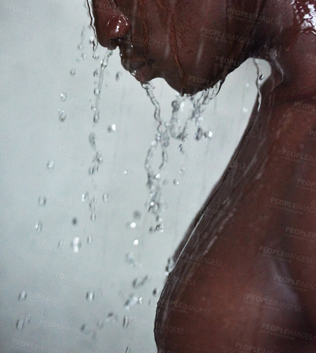 Buy stock photo Black man, water splash and shower with drops for hygiene, grooming or skin hydration on a gray studio background. Closeup of Young African, model or male person with mineral liquid for clean wash