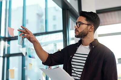 Buy stock photo Business man, paperwork or documents in office with sticky notes for brainstorming or production plan. Confident, male person or creative director with headshot on transparent wall for casting