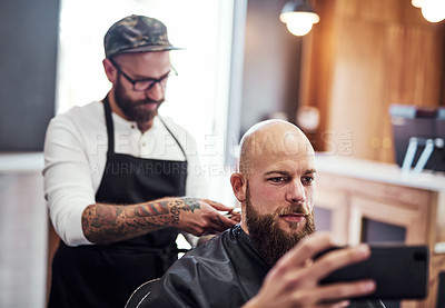 Buy stock photo Phone, client and man in barbershop with hair care, cut and tools for trendy hairstyle at small business. Selfie, barber and customer in chair for grooming service, haircut skills and clean trim.