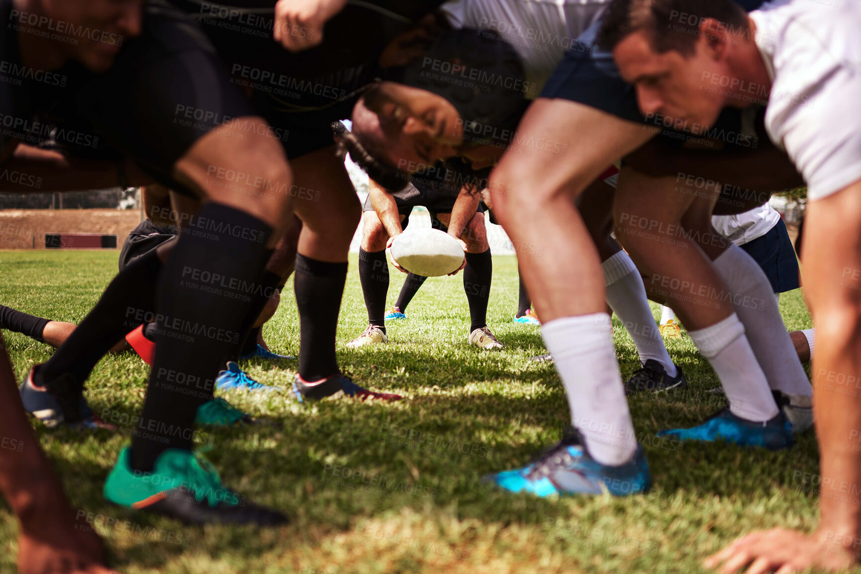 Buy stock photo Cropped shot of a group of rugby players in a scrum on the field