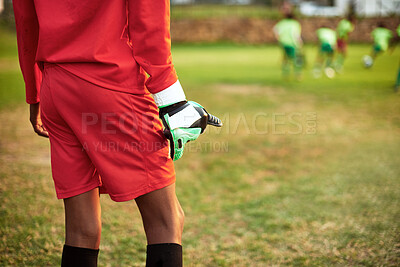 Buy stock photo Closeup shot of a young boy standing as the goalkeeper while playing soccer on a sports field