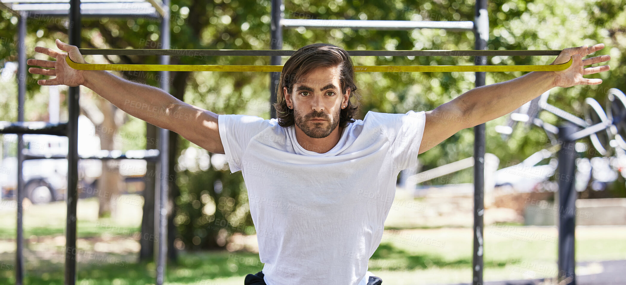 Buy stock photo Man, portrait and stretching with rubber in park for exercise, training and workout outdoor in nature. Fitness, male person and resistance band for muscle strength, flexibility and wellness in sports