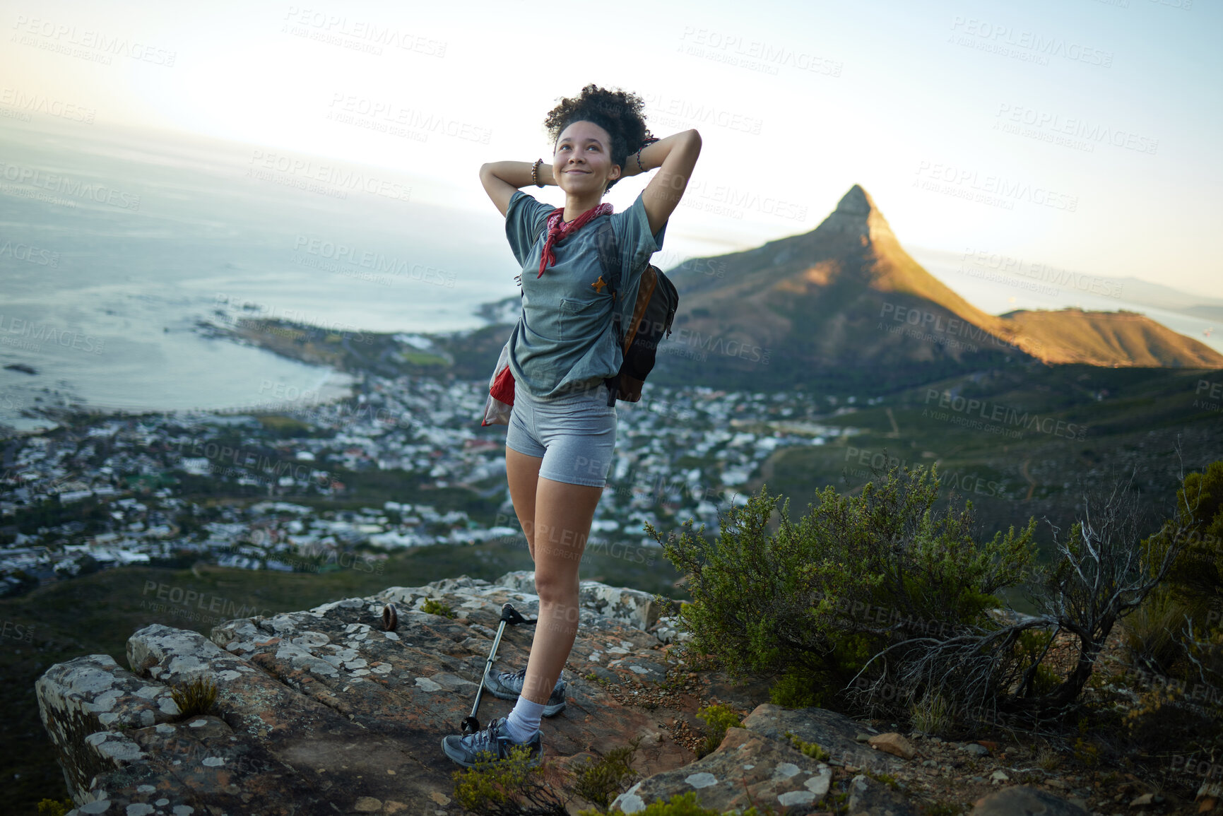 Buy stock photo Woman, hiking and mountain cliff with cityscape for trekking victory or explore adventure, exercise or wellness. Female person, happiness and morning or summit view in California, cardio or walking