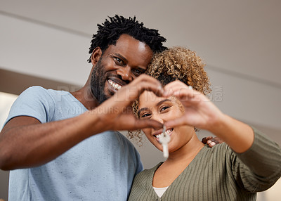 Buy stock photo Couple, fingers and heart with key in new home for real estate, smile with happiness in marriage. People, closeup and hands for gesture of love in house or apartment, mortgage or loan for investment