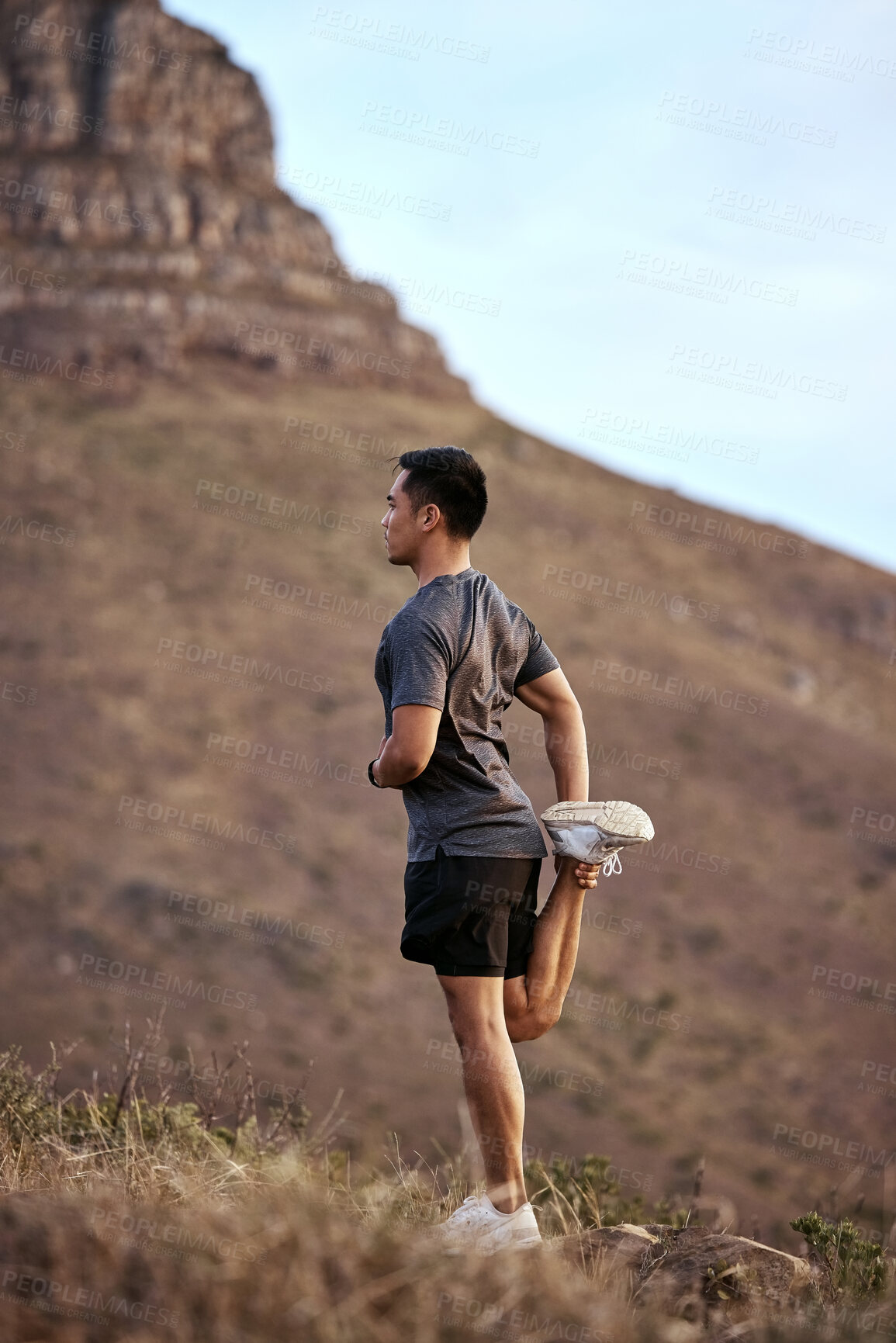 Buy stock photo Athlete, man and fitness on mountain by stretching in outdoors for exercise, training and workout for health. Active and male person in Mexico on path for muscles, wellness and calm in nature
