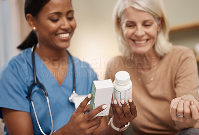 Buy stock photo Shot of a doctor discussing medication options during a a consultation with a senior woman at home