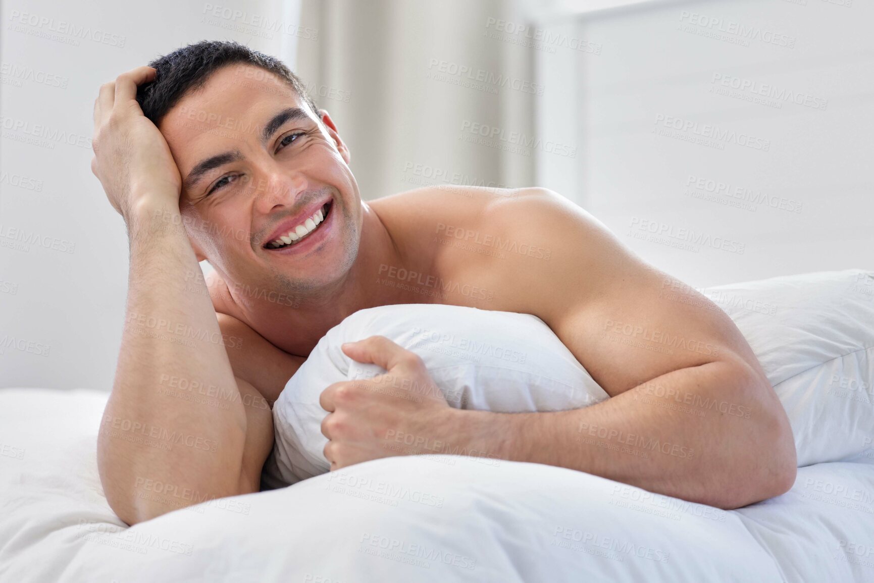 Buy stock photo Morning, portrait or happy man with blanket, cover or pillow in bedroom for resting in home, house or apartment. Wake up, relax or guy sleeping on break with peace, smile or wellness on weekend chill