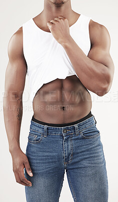 Buy stock photo African man, body and abs in studio for fitness, wellness and workout progress by white background. Athlete, bodybuilder and stomach with muscle, tshirt and jeans with confidence and pride for sport