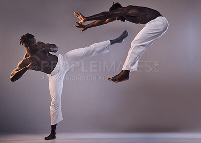 Buy stock photo Fight, karate and black people with kick in studio for martial arts fitness, action exercise or learning. Grey background, coaching clone or athletes in training challenge, workout or double exposure