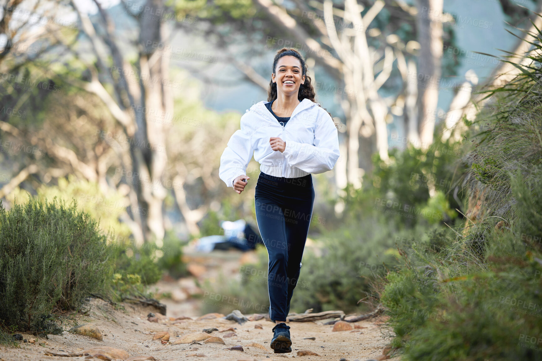 Buy stock photo Shot of a young woman going for a run