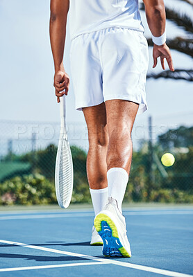 Buy stock photo Cropped shot of an unrecognisable man bouncing a tennis ball during practice