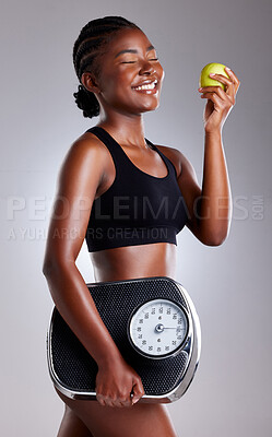 Buy stock photo Diet, scale and black woman with apple for health, nutrition or fitness for body wellness isolated on white studio background. Smile, weight loss and eating fruit for organic food with eyes closed