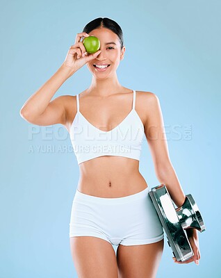 Buy stock photo Portrait, woman or apple with scale in studio for healthy diet, lose weight or nutrition for wellness. Fitness model, underwear or fruit for weightloss progress or measure fat loss on blue background