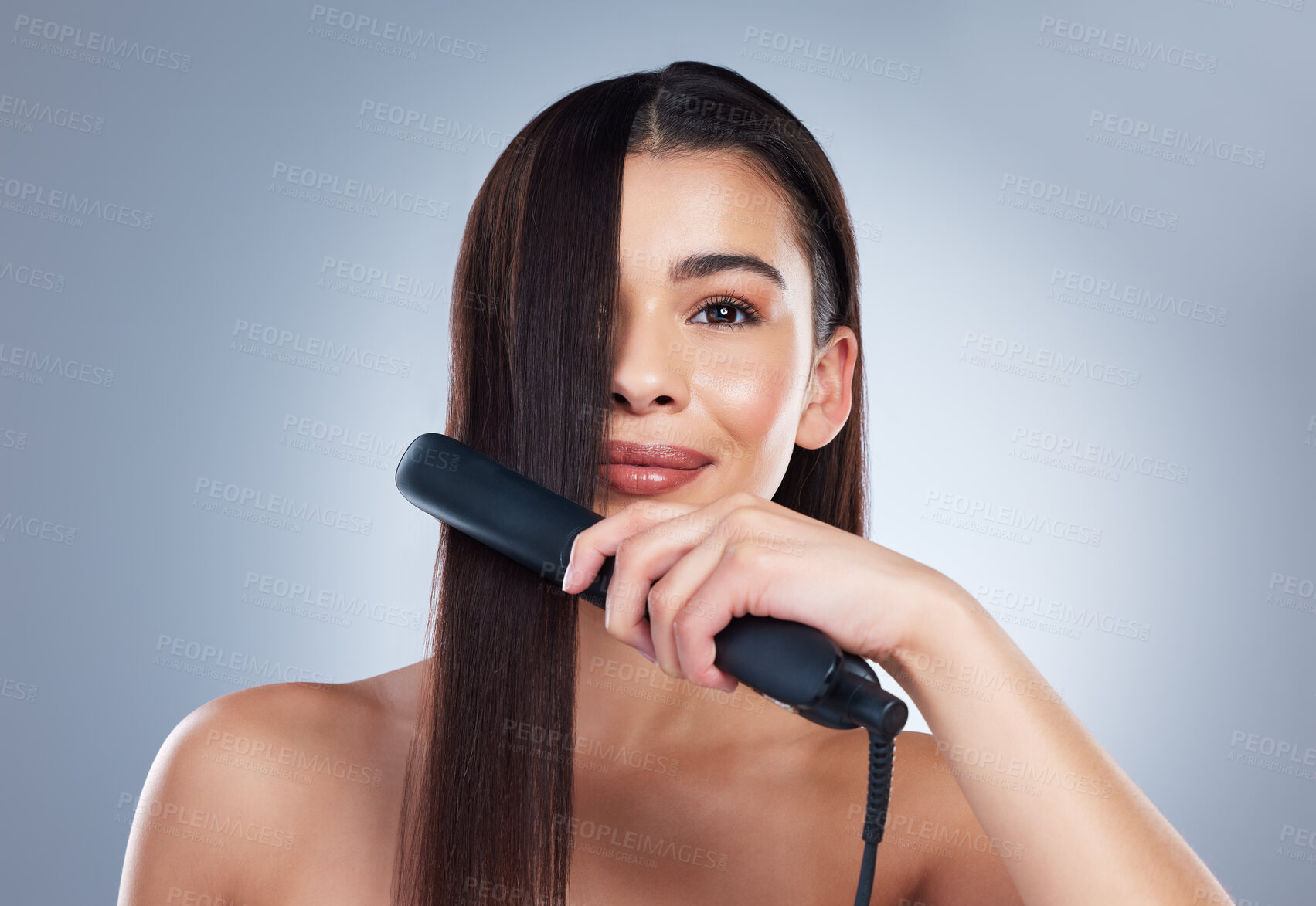 Buy stock photo Happy woman, portrait and hair with straightener for heat, care products or treatment on a studio background. Female person, brunette or young model with flat iron for smooth, sleek or soft texture 