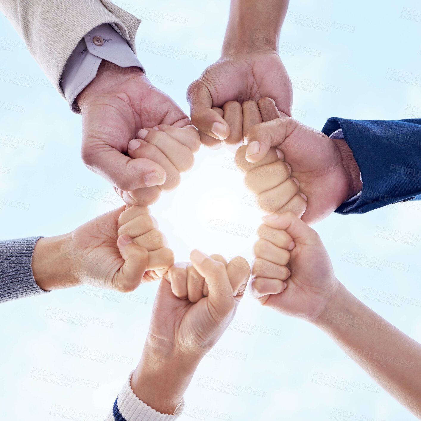 Buy stock photo Business people, teamwork and fist bump outdoor for group solidarity or synergy and power with success. Employees in low angle and sky for hands together, mission and integration circle with support