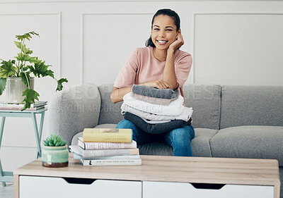 Buy stock photo Woman, home and happy portrait with laundry, living room and towels for house keeping service for hospitality. Smile, maintenance and washing or clean clothes, chores or job and cleaning on sofa