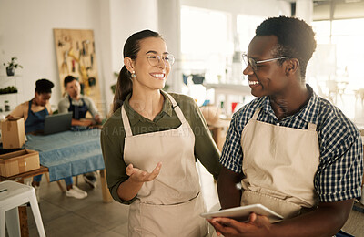 Buy stock photo Two happy, smiling and diverse business owners browsing online, searching the web and planning on tablet while working at a textile factory together. Creative designers smiling and looking at orders 