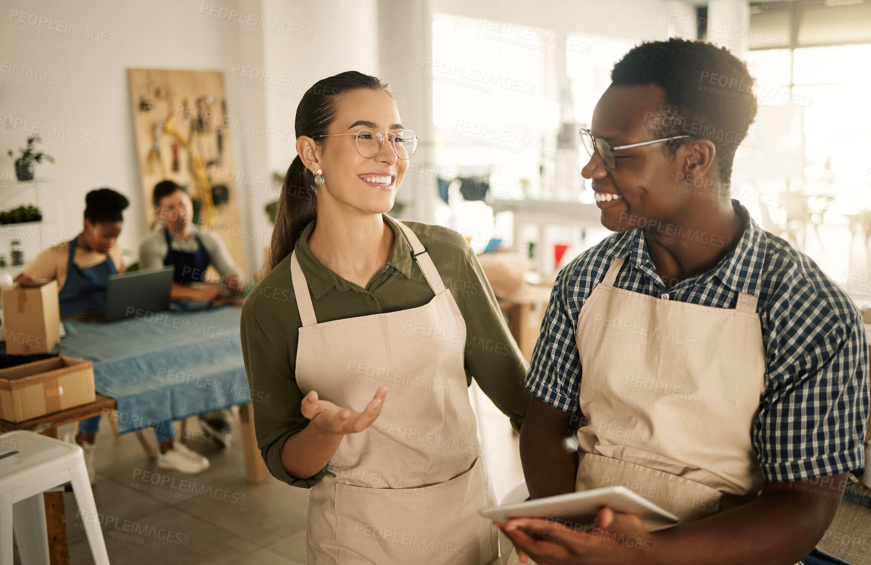 Buy stock photo Two happy, smiling and diverse business owners browsing online, searching the web and planning on tablet while working at a textile factory together. Creative designers smiling and looking at orders 