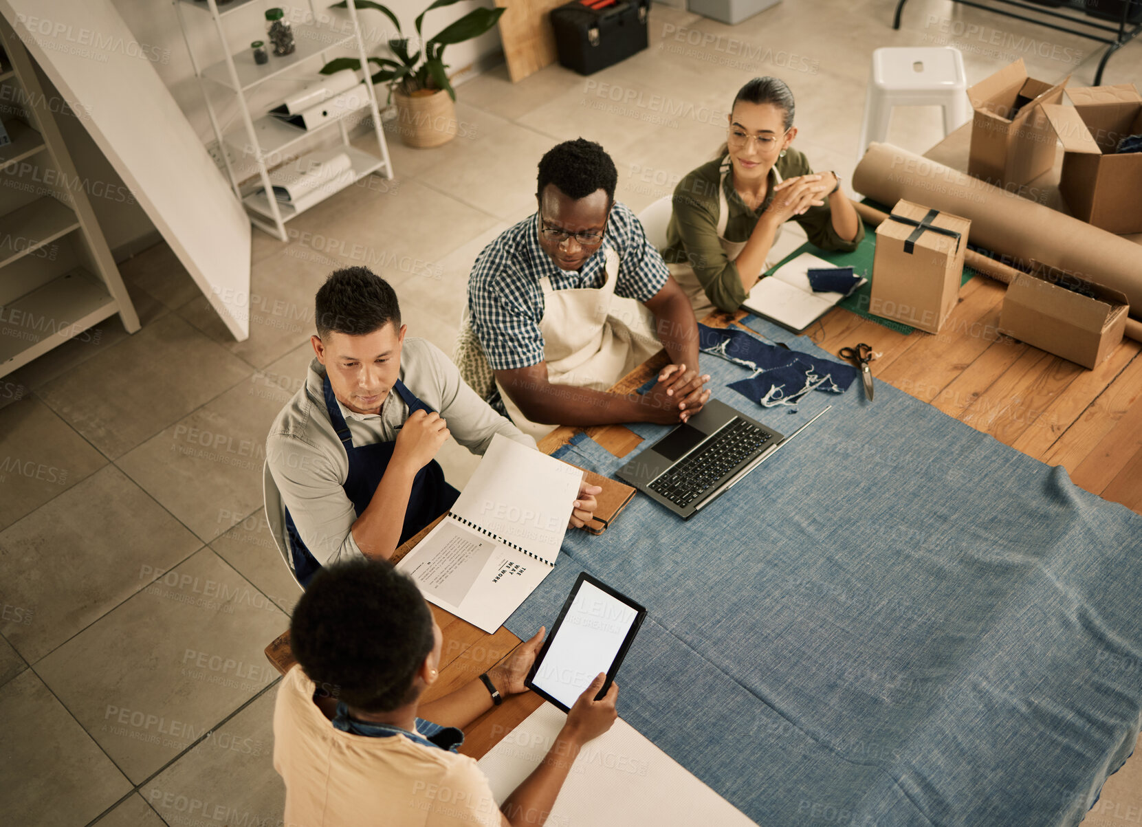 Buy stock photo Fashion designers, colleagues and creatives meeting to discuss and brainstorm a clothing range in a workshop from above. Team planning garment designs in a textile and manufacturing studio or factory