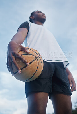 Buy stock photo Basketball athlete ready for training, game and competition on sports court from below outdoor. Thinking, focus and fitness young black man with motivation, mindset and goal to play, win and have fun