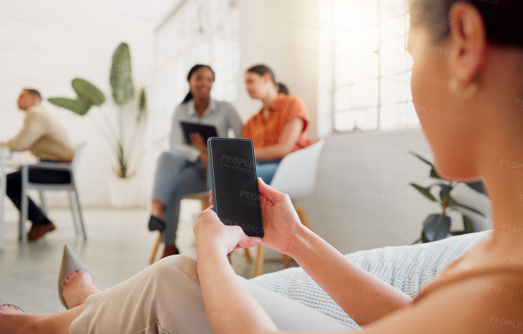 Buy stock photo Businesswoman on a phone with blank screen copy for website, marketing or advertising app with colleagues in background. Corporate worker holding, showing space on cellphone in vibrant workplace