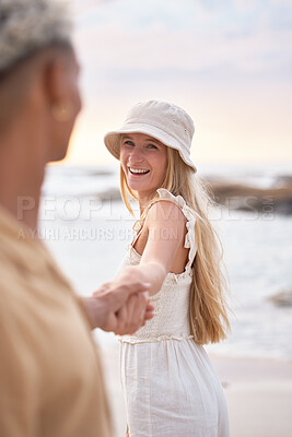 Buy stock photo Interracial, beach and couple holding hands, smile and relationship with vacation, honeymoon and marriage. Seaside, man or happy woman with joy, travel or love with weekend break, excited and holiday