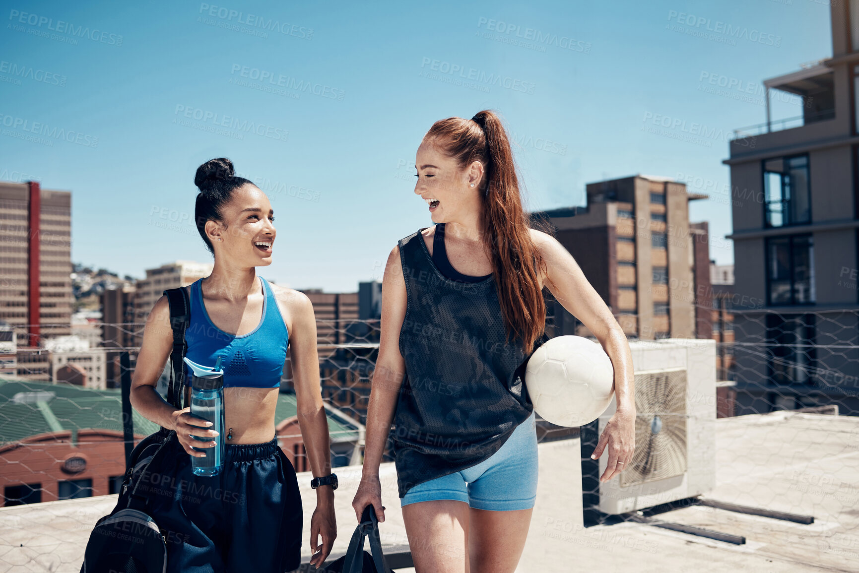 Buy stock photo Women go to sports training with ball, rooftop city sports in Colombia or walking to football game. Friends exercise together, happy to exercise in urban lifestyle or healthy soccer coach workout